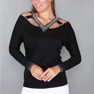 Nice top fits small or medium with righnstones on the chest